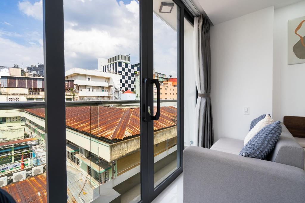 Balcony door open to a street view at Ekomo Home 95 - Metro Ben Thanh