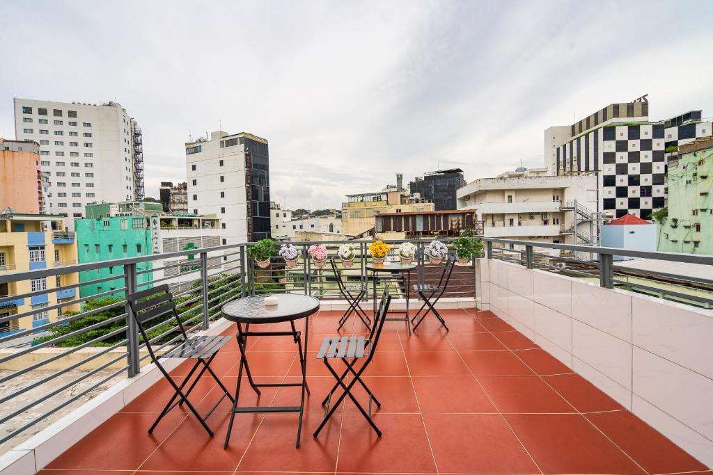 Rooftop terrace seating with a view over District 1 at Ekomo Home 95 - Metro Ben Thanh