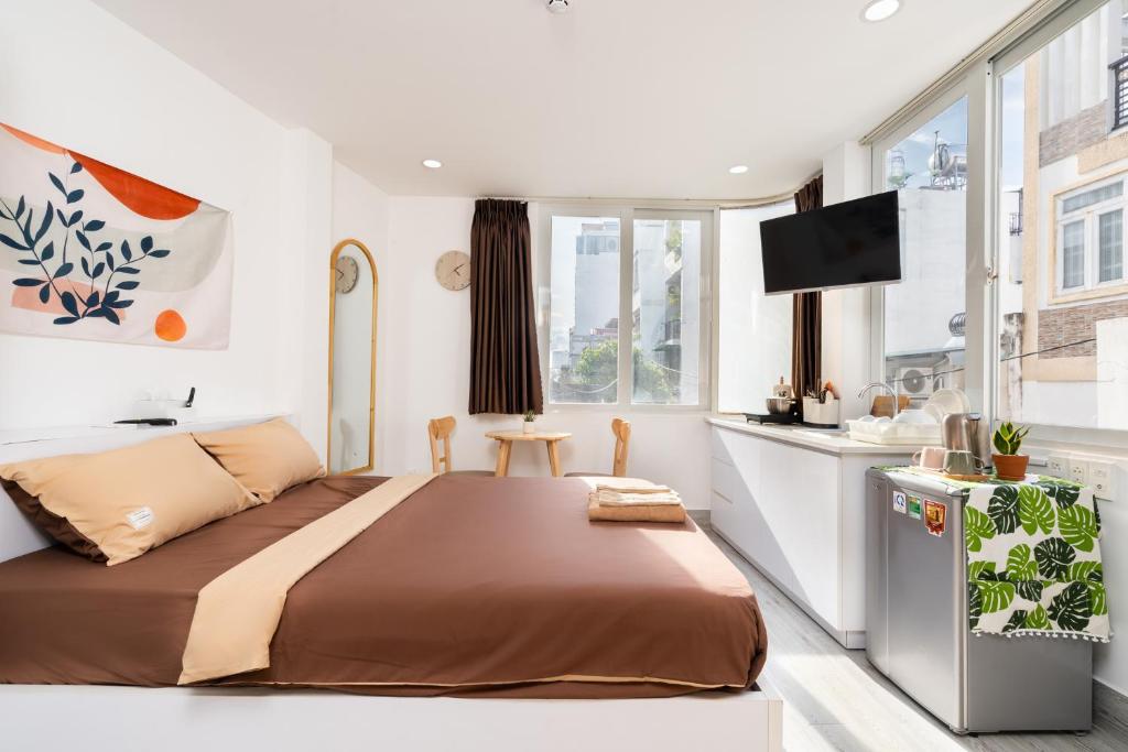 Queen room with in-room kitchenette visible at Ekomo Home 102 - Central Saigon
